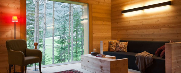 The panoramic windows in the living area allow beautiful views of the natural park, but large wooden sliding units in both the main and secondary building allow shading of the panoramic windows if required.