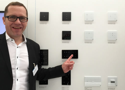 ABB Global Marketing Communication Manager, Olaf Stutzenberger, pointing out a range of ABB-tacteo KNX sensors.