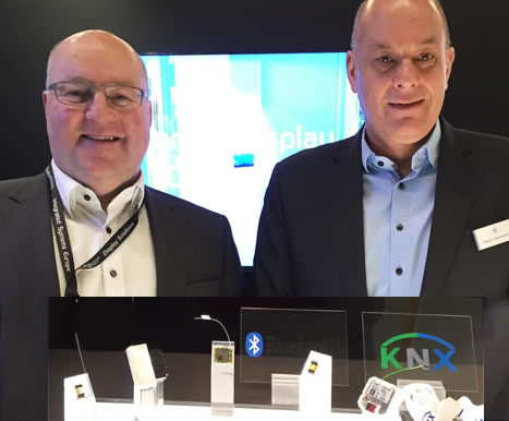 (L-to-R) ZF Friedrichshafen Sales Manager, Anton Hartmann, and Key Account Manager Industrial Switches, Markus Bachmeyer, showing the core element of the KNX-RF module in bi-stable and mono-stable versions, and the media coupler from KNX-RF to KNX-TP.